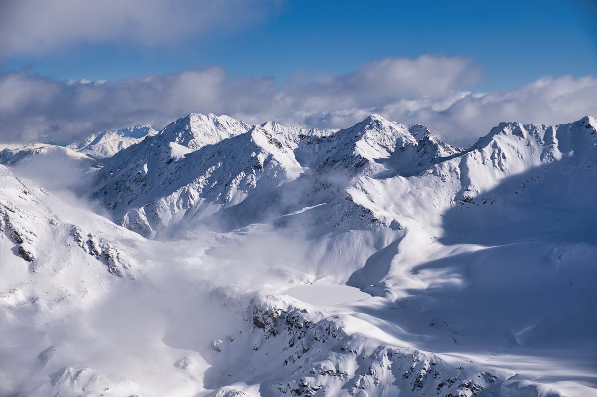 Mountain peaks with snow and fog atmospheric landscape