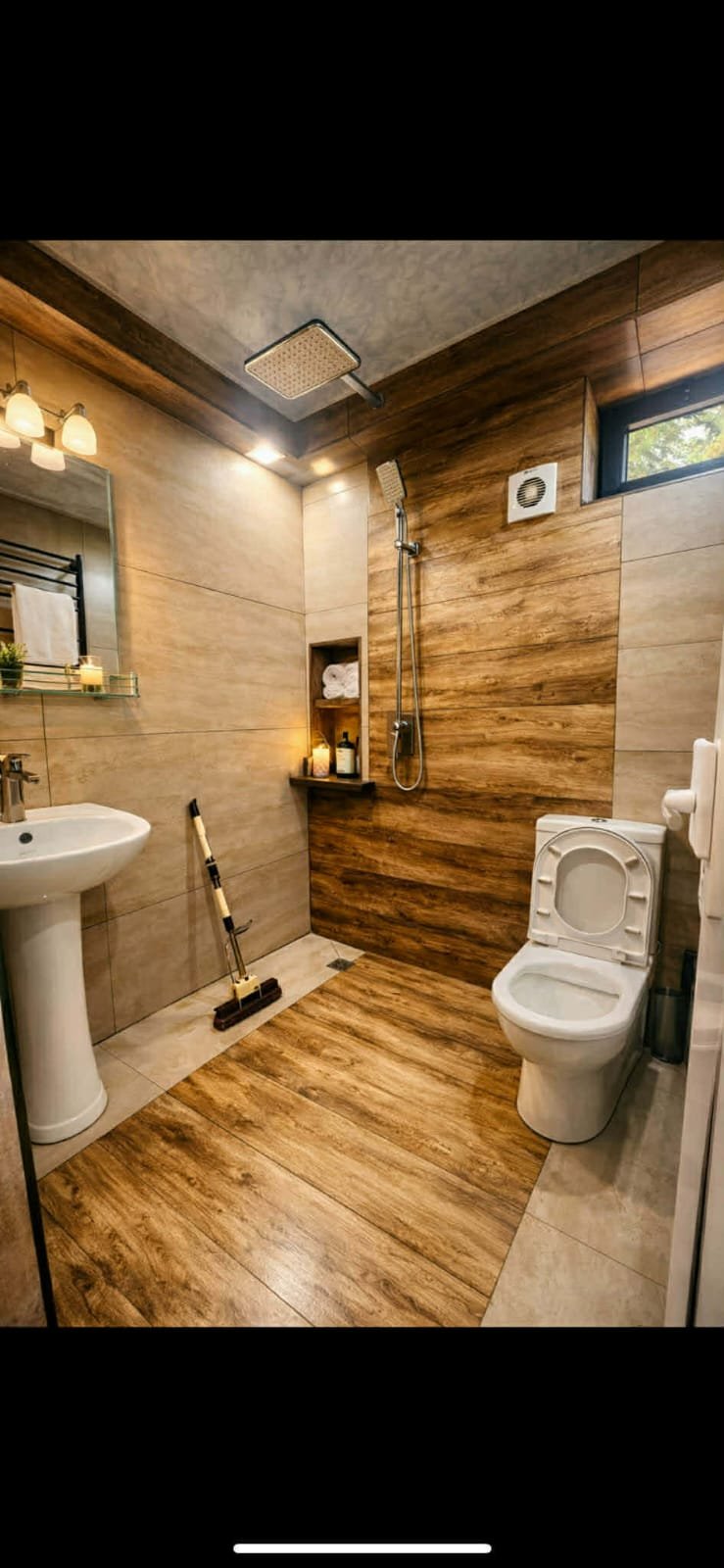 Modern luxury bathroom with wood-grain tile walls, pedestal sink, white toilet, walk-in shower with rainfall showerhead, and ambient lighting